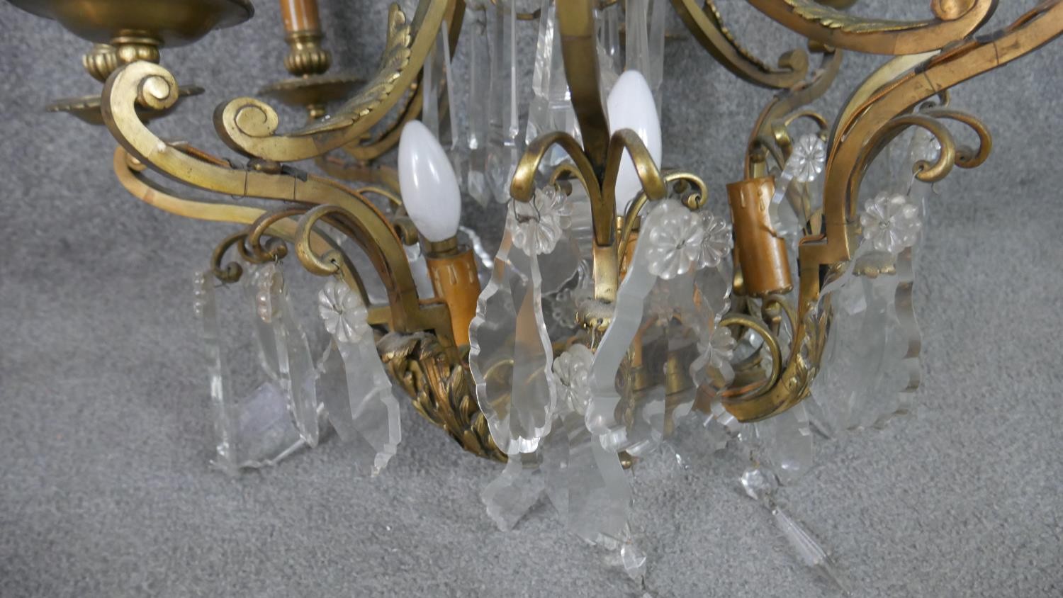 A scrolling gilt brass and crystal eight branch chandelier with hanging crystal drops and foliate - Image 7 of 11