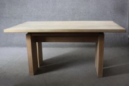 A contemporary light oak planked top dining table on block supports. H.74 W.160 D.100 cm.
