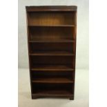 A mahogany bookcase, with a dentil cornice over five shelves, on shaped bracket feet. H.170 W.80 D.