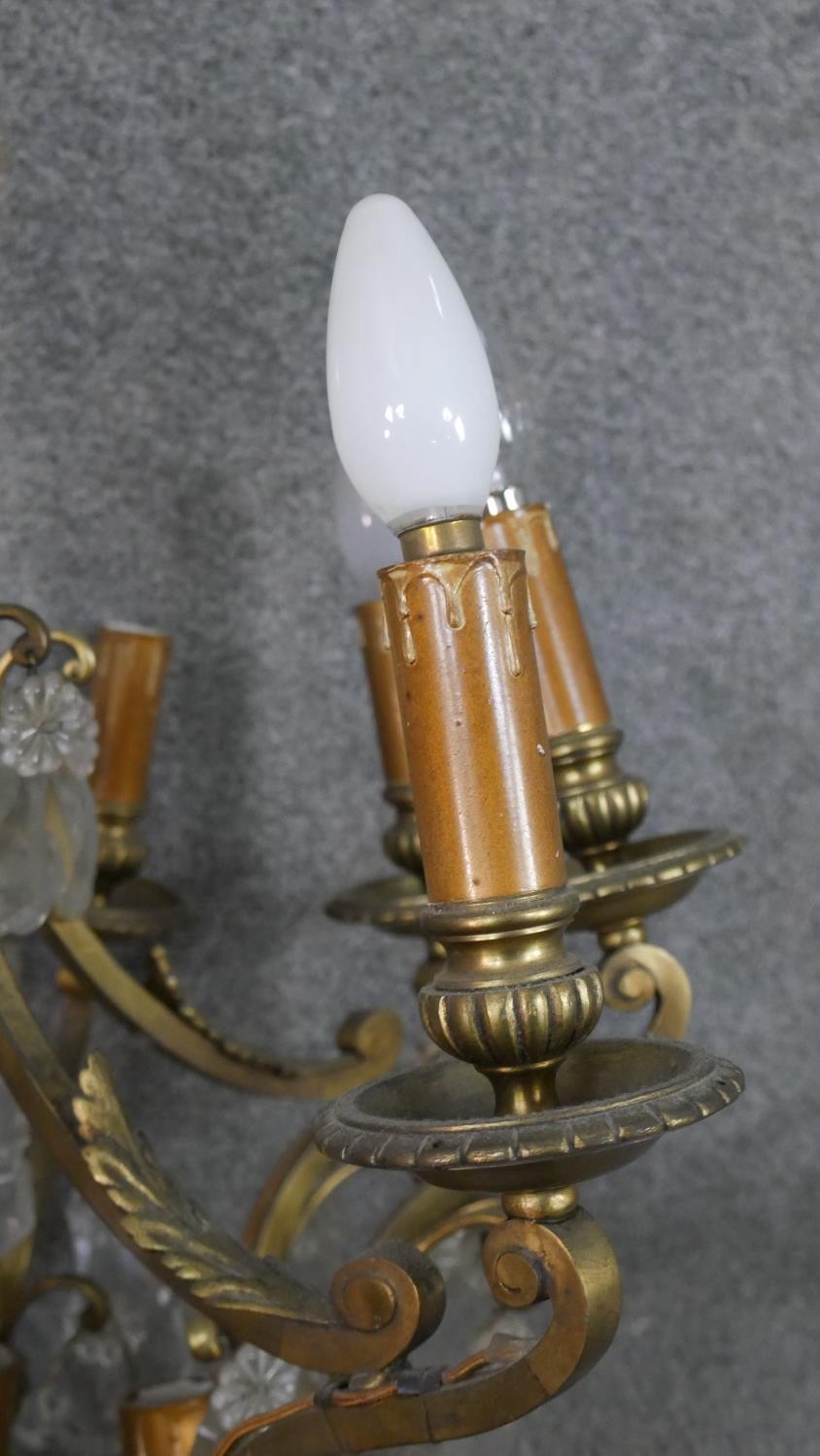 A scrolling gilt brass and crystal eight branch chandelier with hanging crystal drops and foliate - Image 4 of 11