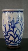 A large Oriental blue and white ceramic stylised floral design vase. H.36 Diam.21cm (inc. stand)