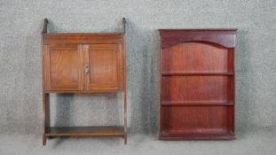 A late Victorian wall mounted cabinet, two cupboard doors over an undertier, together with a