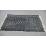 A Pakistan Bokhara blue ground hand made rug. L.164 W.96cm.