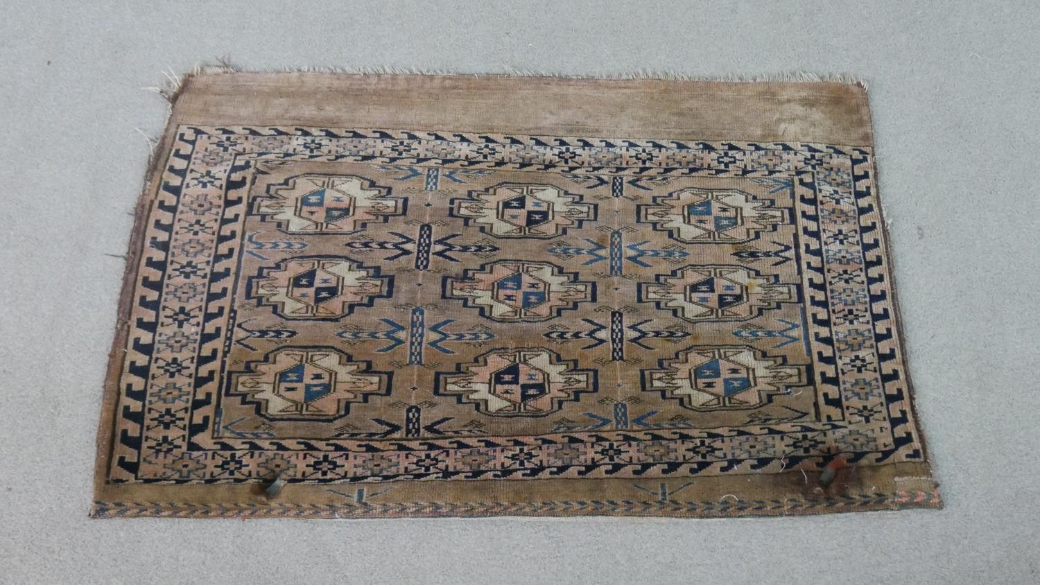 A tan ground fine handmade Turkman saddle bag. L.113 W.73cm