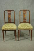 A pair of Sheraton style Edwardian walnut dining chairs, the pierced splat back with inlaid