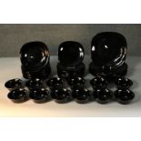 A twelve person black glass dinner service. Marked ARC, France to base.