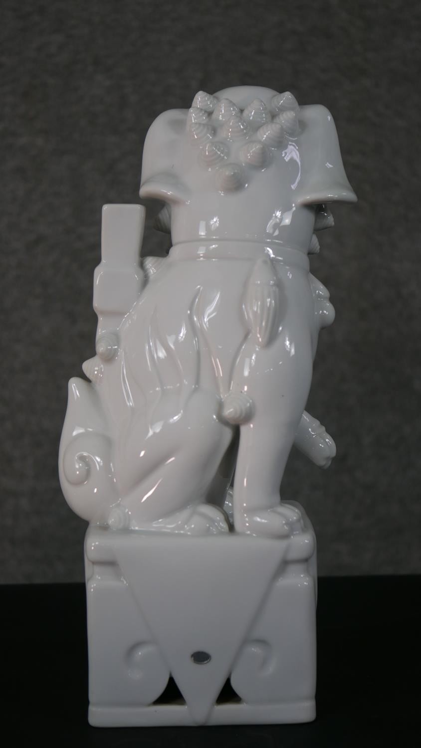 A 20th century blanc de chine Chinese ceramic foo dog on pierced square base. H.35 W.12 D.10cm - Image 4 of 6