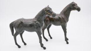 A pair of early 20th century leather horses with brass bridle and leather reins. H.32 W.9 D.36cm