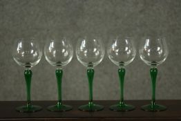A set of five green stem wine glasses. H.19cm