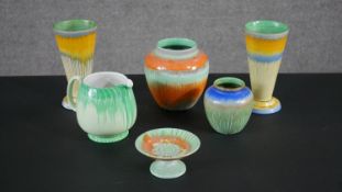 A collection of Art Deco colourful hand painted Shelly porcelain, including two conical vases, a