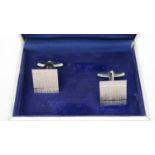 A boxed pair of textured silver square cufflinks with hinged torpedo fittings, stamped 925.