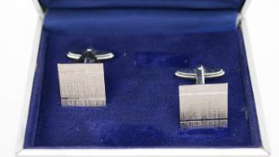 A boxed pair of textured silver square cufflinks with hinged torpedo fittings, stamped 925.