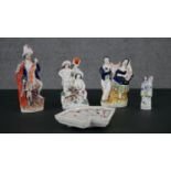 A collection of four 19th century Staffordshire flat back ceramic figures and a playing card