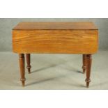 A Victorian Pembroke table, with drop leaves over an end drawer, on turned legs. H.70 W.44 D.