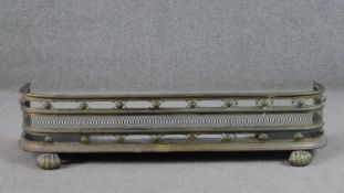 A George III style brass fender, with curved ends and pierced detail. H.23 W.96 D.34cm