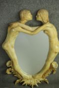 A ceramic framed wall mirror of two figures embracing in a kiss. Signed A. Gambaretto, label