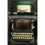 A St. Martin's black enamelled portable typewriter, in case with maker's label to the inside. H.25