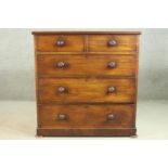 A Victorian mahogany chest of two short over three long drawers, with turned handles, on a plinth