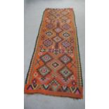 A Persian Kelim rust ground hand made runner. L.224 W.80cm