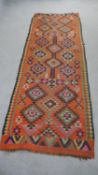 A Persian Kelim rust ground hand made runner. L.224 W.80cm