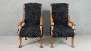 A pair of Regency style open armchairs, upholstered in black sheepskin style fabric, with curved