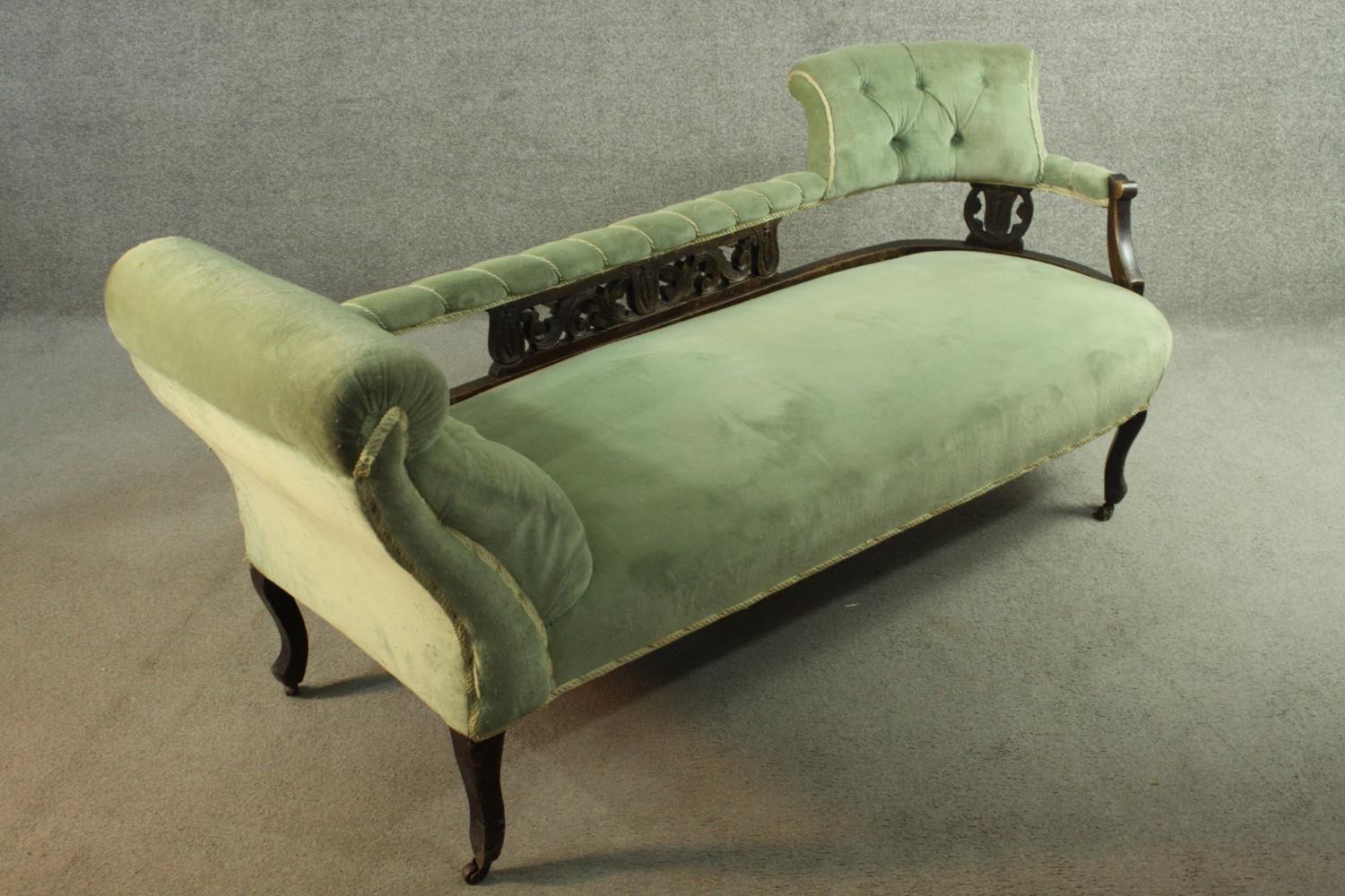 An Edwardian chaise longue, upholstered in green buttoned velour, the back panel carved and - Image 2 of 8