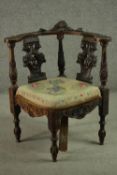 A late 19th century Italian corner chair, carved with a mask to the back rail, over two ornately