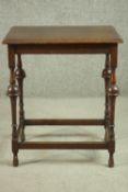 An oak occasional table of unusual form, the rectangular top with a moulded edge, on turned legs,