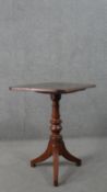 A 19th century mahogany tripod table, with a rectangular tilt top on a turned stem. H.69 W.62 W.44.