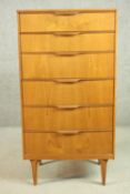 A circa 1960's teak Grange tallboy chest of six long drawers, on shaped tapering legs, bearing label