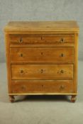 A pine chest of four long drawers, on turned feet. H.94 W.84 D.42cm