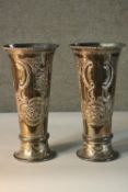 A pair of engraved silver plated trumpet vases, decorated with scrolling design and floral motifs.