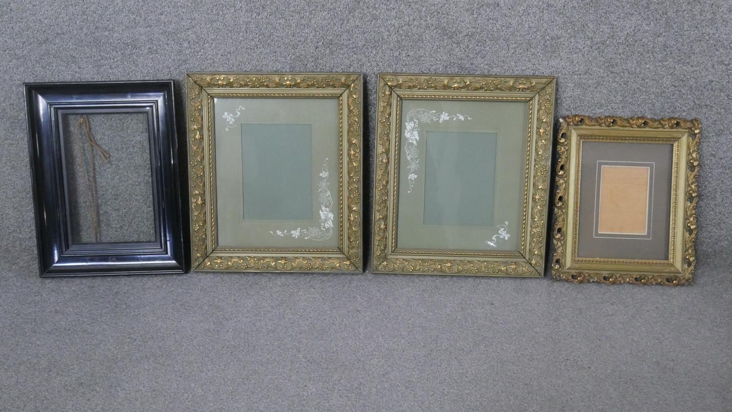 Four picture frames, including a pair of gilt frames with repeating foliate design, another gilt