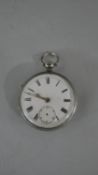 A Victorian silver gentleman's pocket watch with white enamel dial and black Roman numerals. (