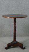 A William IV circular rosewood occasional table, with a carved and turned stem on a tri-form base