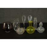 A collection of cut crystal and glass ware, including a yellow art glass vase, a pair of Art Deco