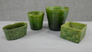 A collection of four various size and shape 19th century pottery green glaze planters with different