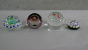 Four art glass lamp work paper weights with various designs. Makers marks to the base.
