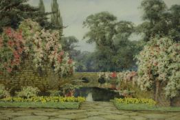 Lilian Stannard (British 1877-1944) watercolour, a formal pond with a bridge and waterlilies, signed