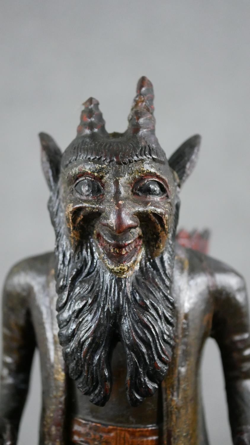 A 19th century carved black forest faun match holder, a pedestal base with red basket on his back. - Image 6 of 6