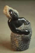 A Zimbabwean School carved soapstone sculpture of a mother and child. Unsigned. H.50cm.