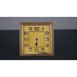 A gilt metal square Art Deco desk clock with easel back. (One hand fallen off) H.15 W.15cm