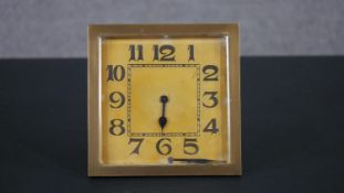 A gilt metal square Art Deco desk clock with easel back. (One hand fallen off) H.15 W.15cm
