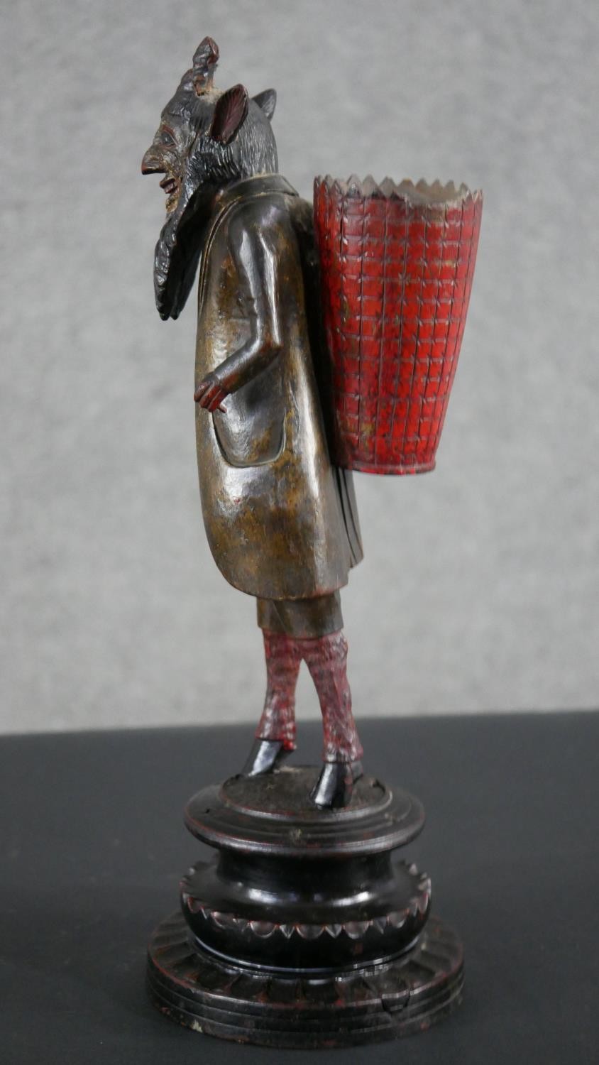 A 19th century carved black forest faun match holder, a pedestal base with red basket on his back. - Image 5 of 6