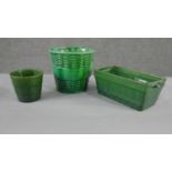 A collection of three various size 19th century pottery green glaze planters with different designs,
