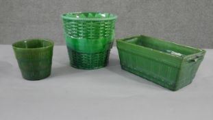 A collection of three various size 19th century pottery green glaze planters with different designs,