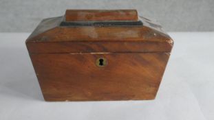 A George III mahogany sarcophagus form tea caddy, with ebonised detail, two wells to the interior.