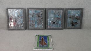 A set of four early 20th century framed stained glass panels depicting foliate designs, together