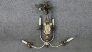 A brass classical design four branch chandelier, with sculptured putti and foliate design ceiling