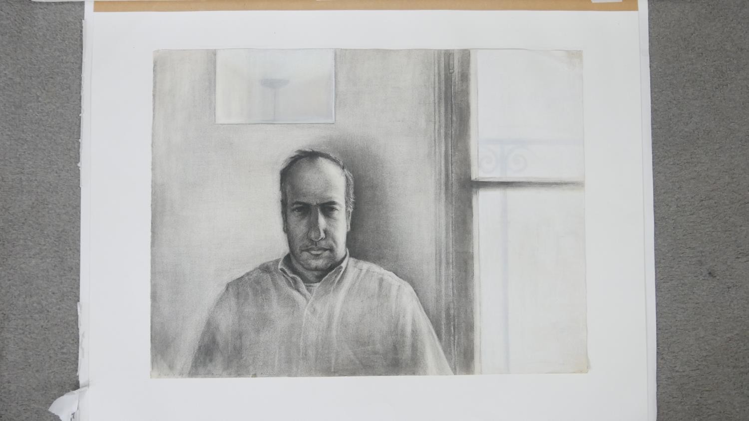 An unframed charcoal portrait of a man by a window, signed R. Levy. H.71 W.86cm (inc. mount) - Image 3 of 7